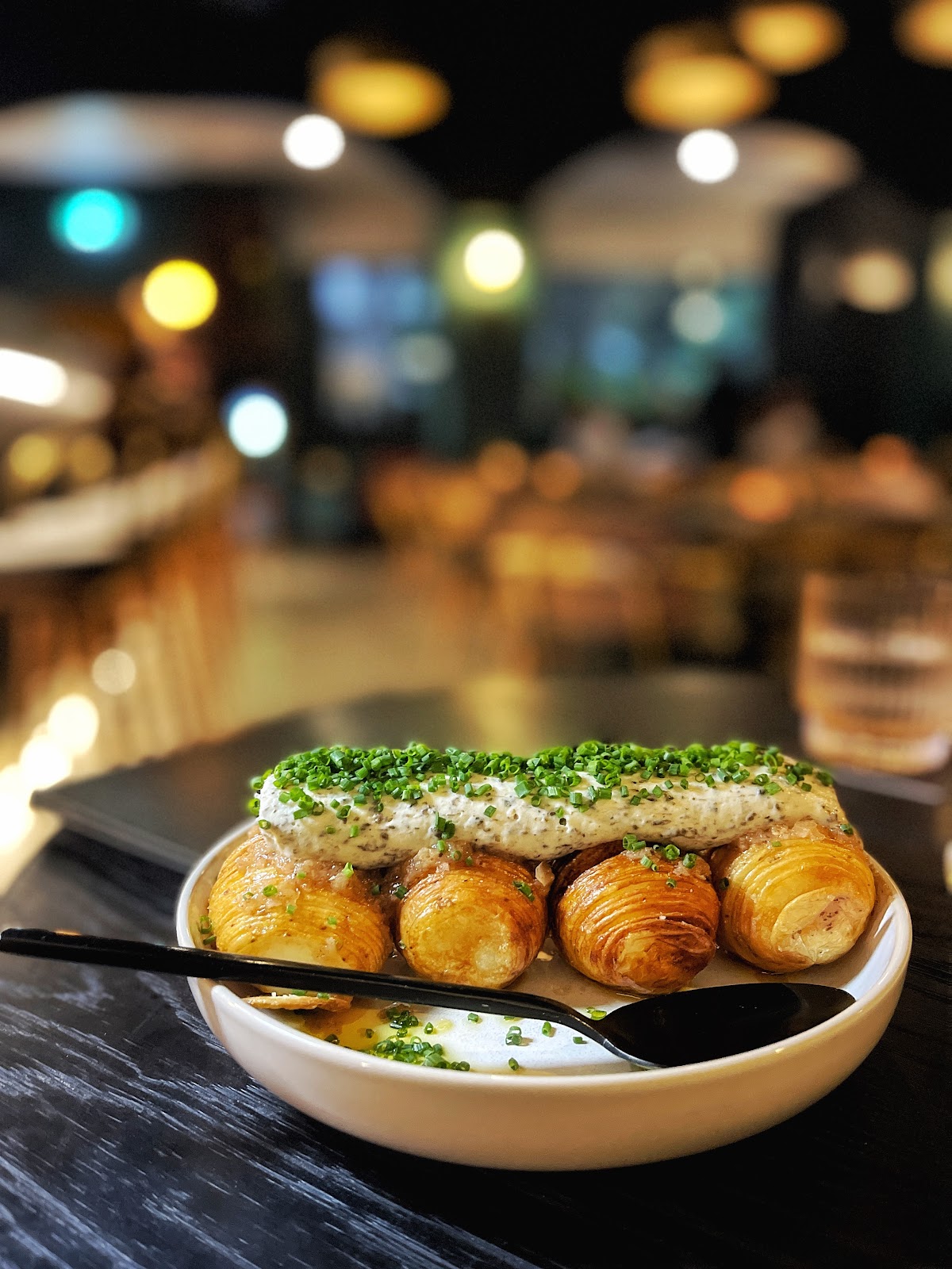 Hasselback potatoes finished with a herb crumb, on the bar